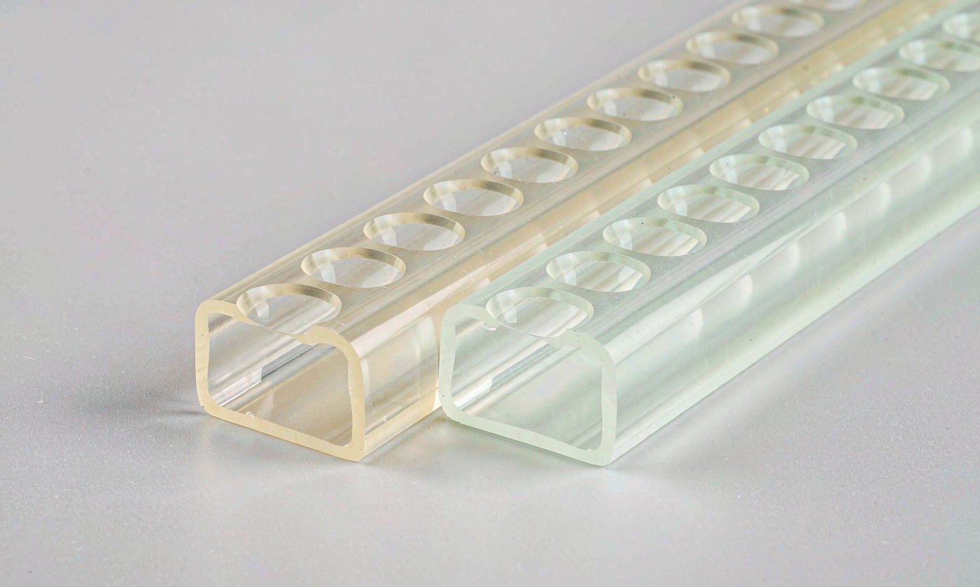 Two extruded LED diffuser sample profiles from different batches compared side by side under even lighting