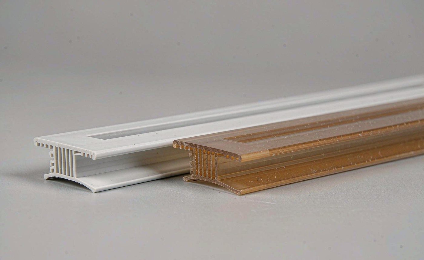A new white LED diffuser profile next to a yellowed polycarbonate diffuser after years of UV and heat exposure